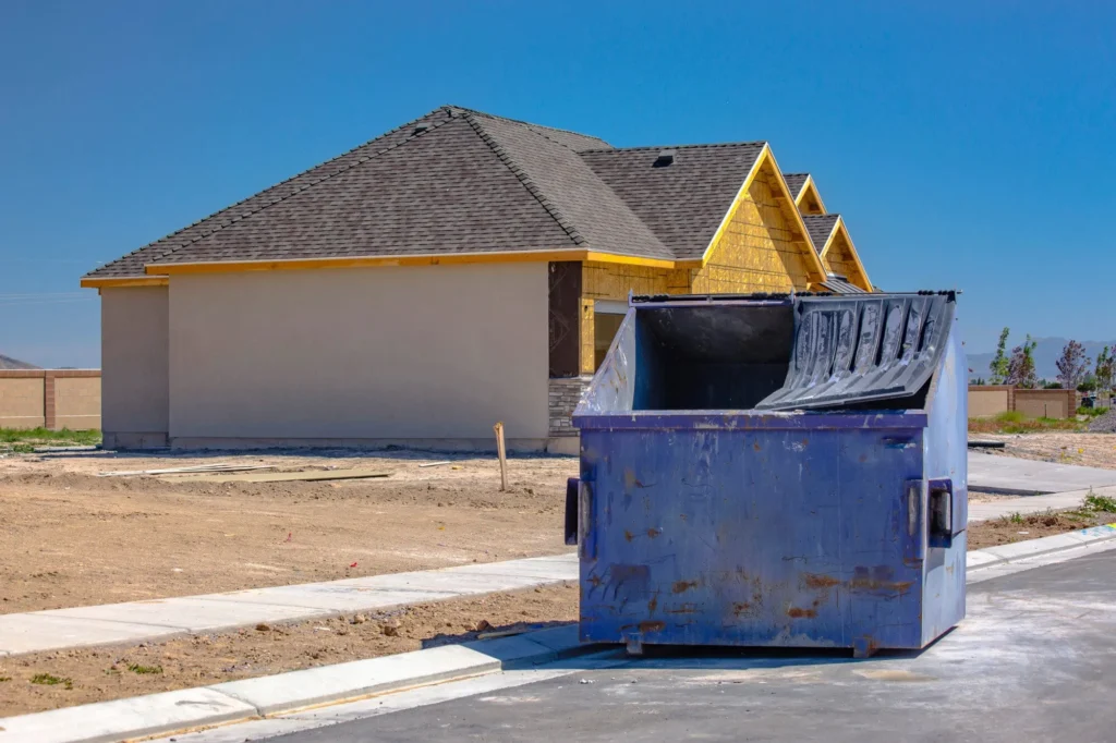 Blue Dumpster in front of house construction